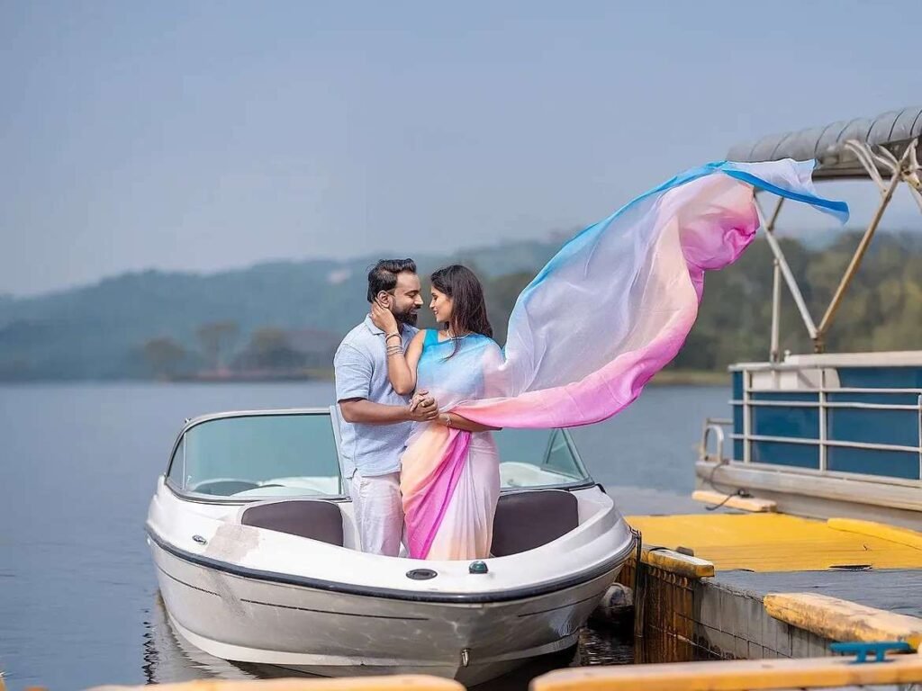 Couple looking into each other's eyes on a boat during a dreamy romantic lakeside pre-wedding shoot