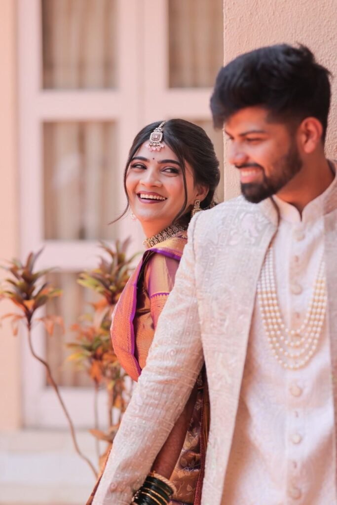 Maharashtrian bride looking lovingly at her groom during a joyful candid wedding moment