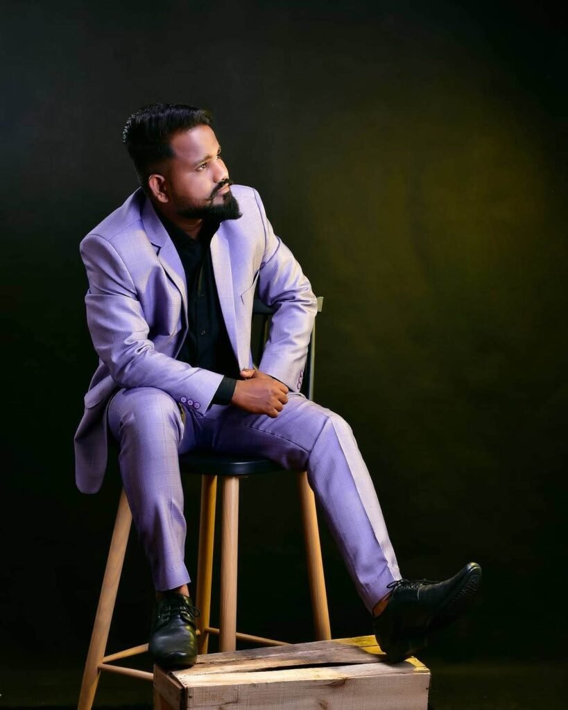 Male model in a lavender suit posing in a stylish studio fashion portrait with rim lighting
