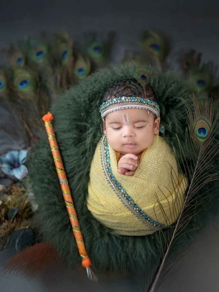 Sleeping newborn baby dressed as Krishna holding a flute with a sandalwood tilak and peacock feathers