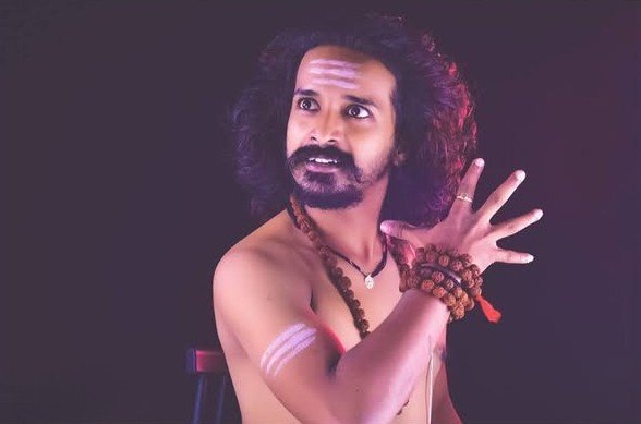 Expressive studio close-up portrait of an artist wearing Tripund and Rudraksha